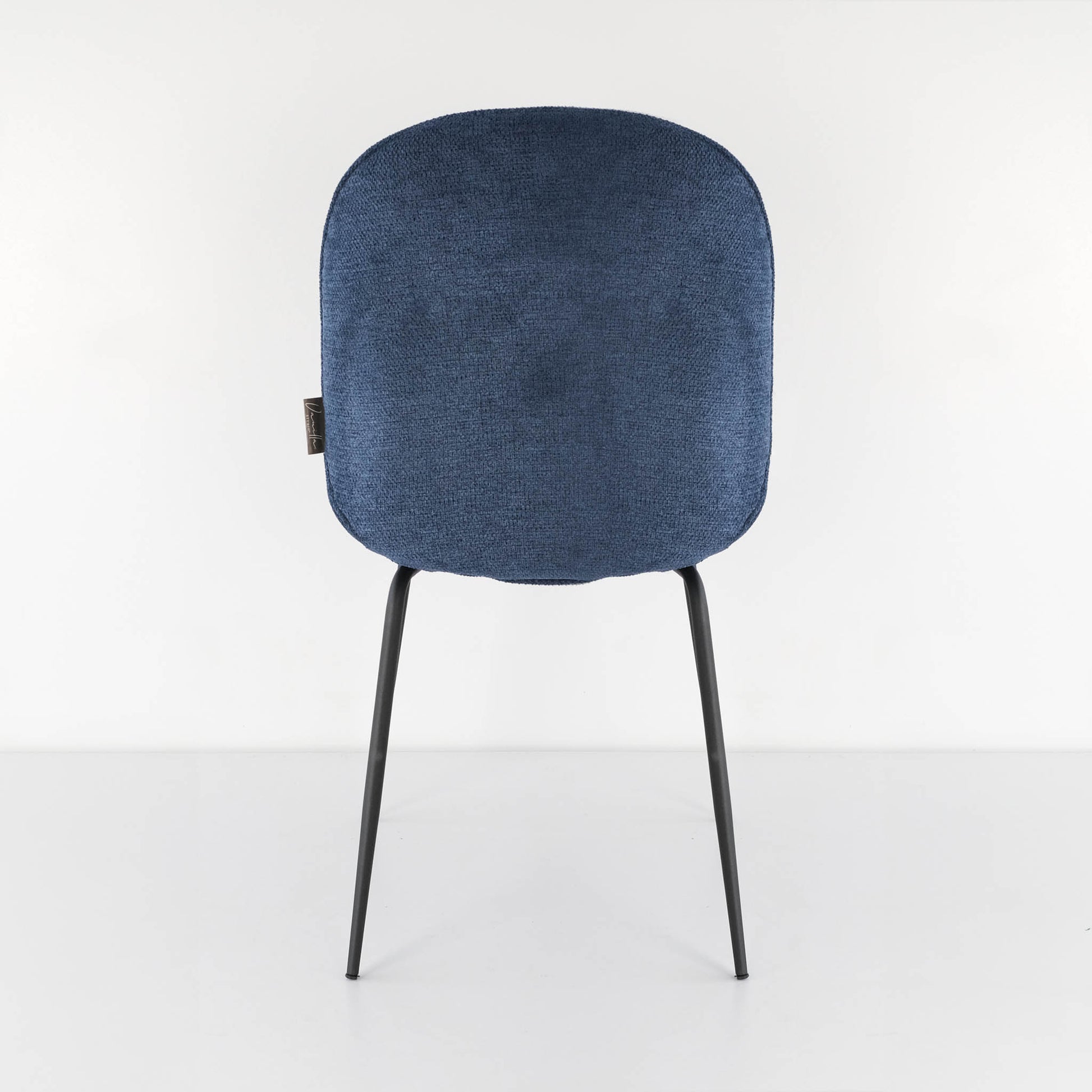 Back view of a vibrant royal blue Beetle dining chair