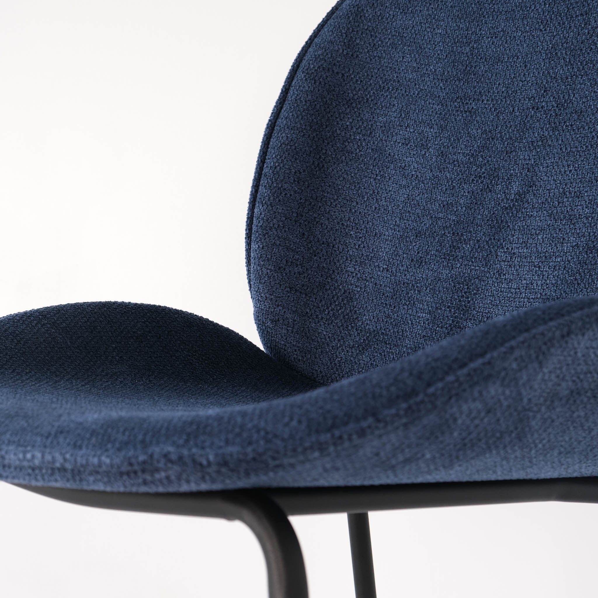 Close up of a royal blue Beetle dining chair
