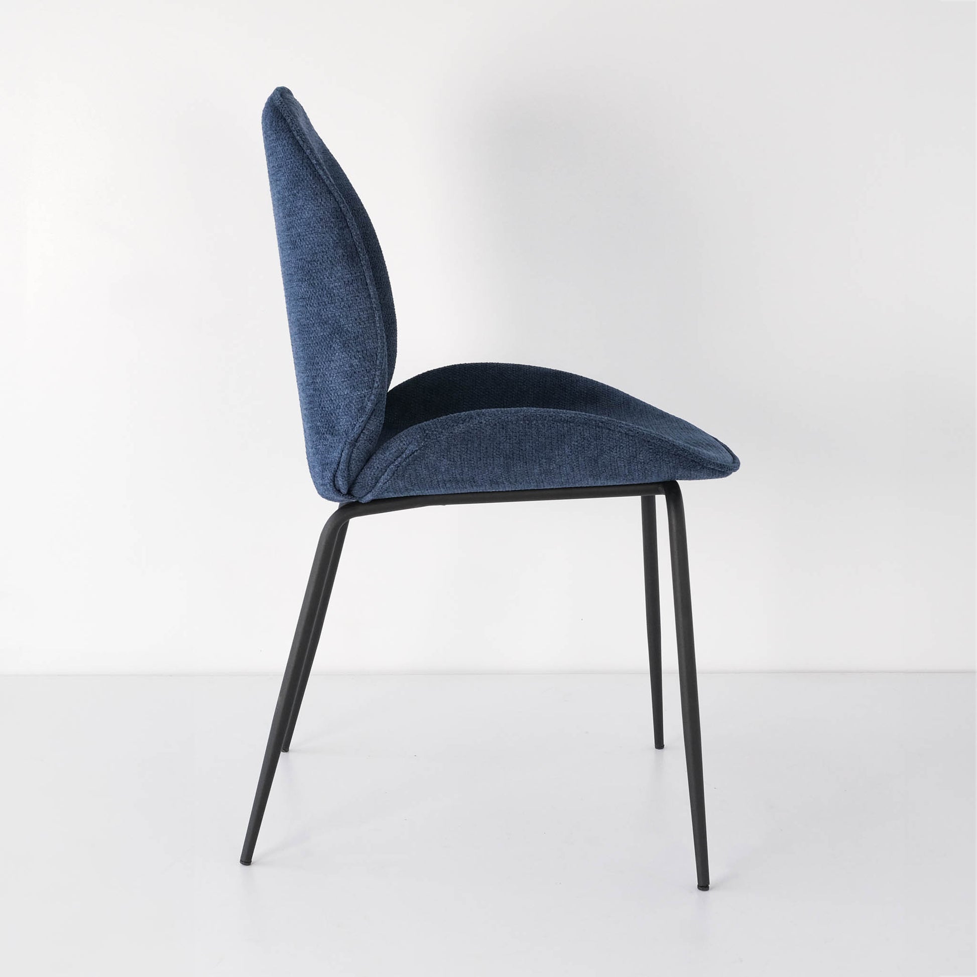 Side view of a vibrant and elegant royal blue Beetle dining chair