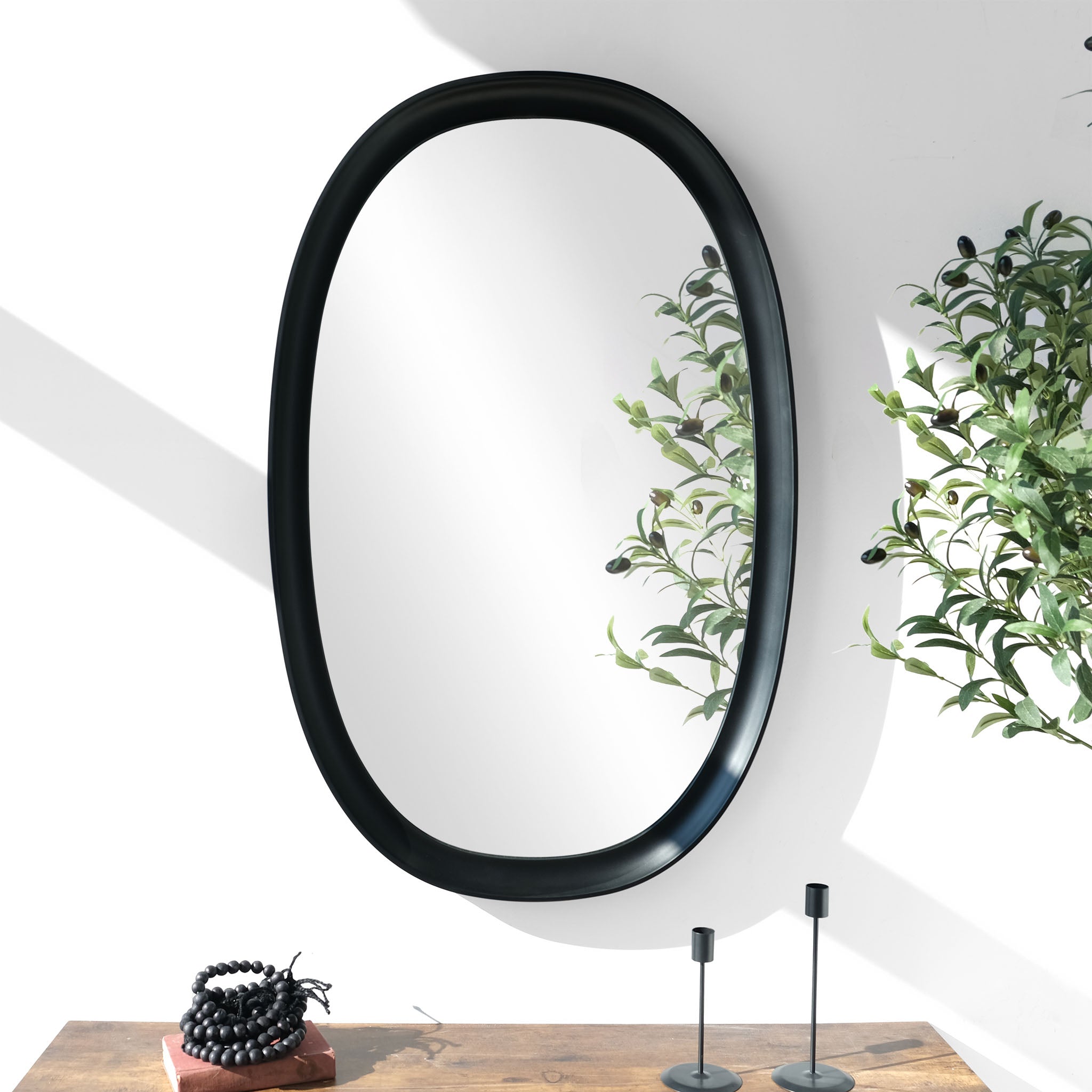Parisienne black oval mirror over a console table