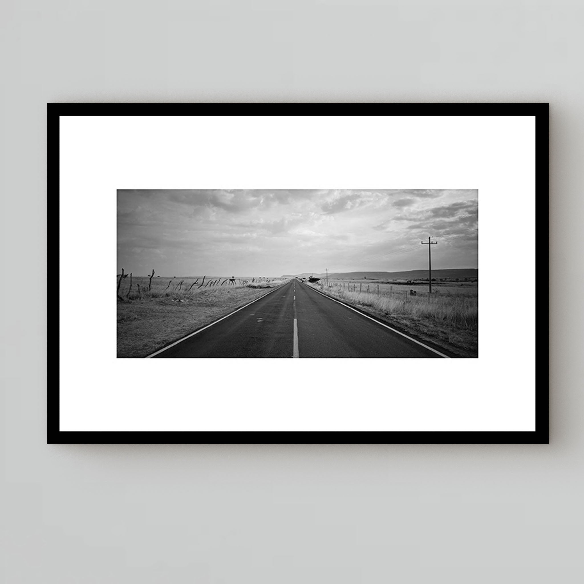 black and white photography under glass of a long road