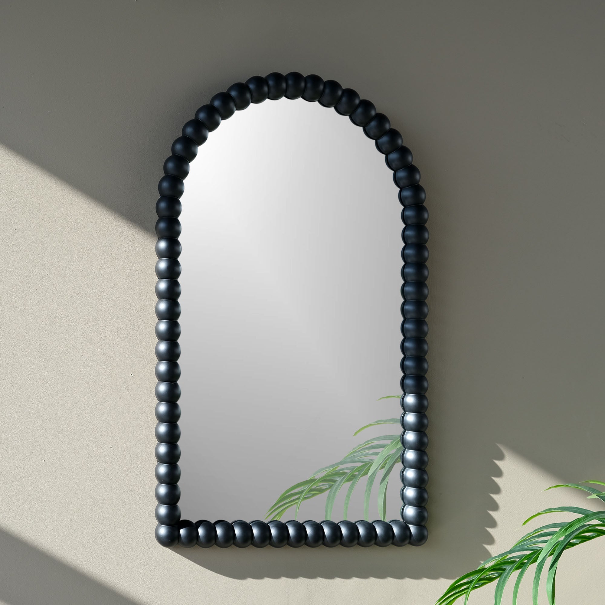 black ball bon bon mirror on wall