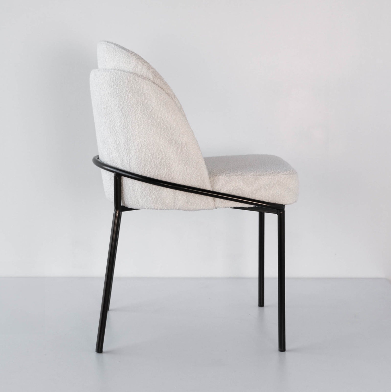 Side view of textured off white boucle accent chair