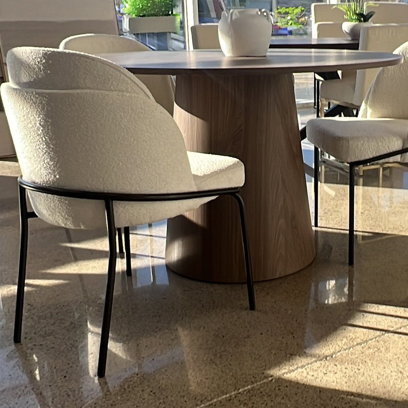 Boucle dining chairs encircling a table